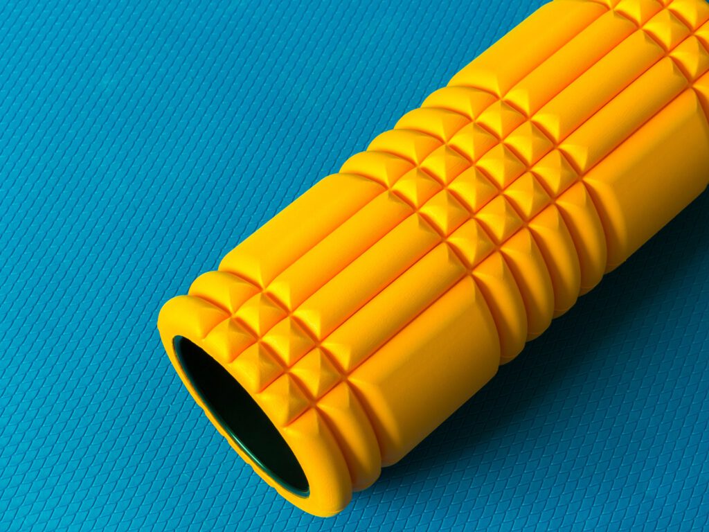 yellow,fitness,foam,roller,on,blue,scale,texture,background,top